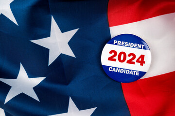 president 2024 candidate text quote on election button laying on the star spangled banner. united states of america concept.