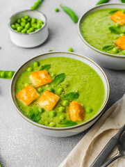 Cream soup bowls pea, mint and fried halluomi. Closeup