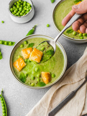 Cream soup bowls pea, mint and fried halluomi. Closeup