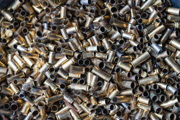 Bunch of empty pistol shells as a background. Pile of used pistol cartridges.