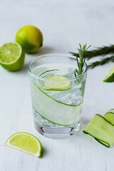 cocktail with lime.Cucumber water with lime and rosemary. glass of lemonade with slices of lime and cucumber on the white table. cold alcohol drinks with copy space. detox water. summer