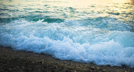 Sea foam on pebbles. Coastal backgrounds.