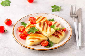Grilled halloumi cheese served with tomatoes and parsley