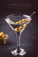 Martini cocktail on dark stone table.
