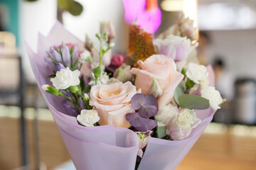 Bouquet with roses as Valentines day gift and surprise, floral background at flower shop or store. Valentine Day bouquet of flowers in pink and lavender very peri color