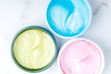 Assortment hyaluronic skin patch mask to reduce puffiness and bruising under the eyes. flatlay. the view from above on a marble background. self-care and spa concept. Mockup.
