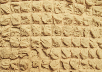 Fabric pattern background of a brown beige Waffle Towel like embossed texture seamless patterned.