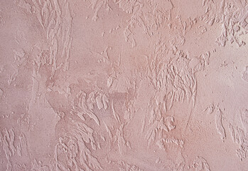 Abstract concrete background with a burgundy hue. Photo with a texture of uneven plaster.