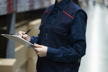 Warehouse worker checking inventory in logistics warehouse