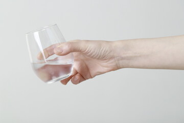 Close up of woman holding glass of water