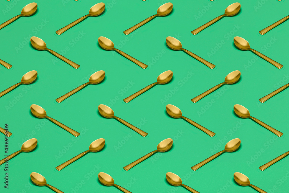 Wall mural pattern with spoons on green surface