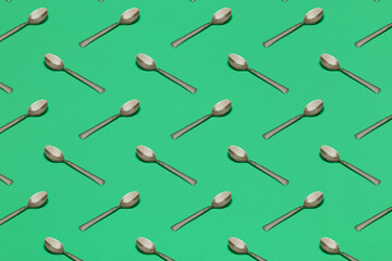 pattern with spoons on green surface