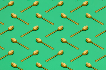 pattern with spoons on green surface