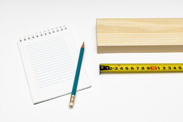 on a white background lies a bar roulette notebook and a pencil