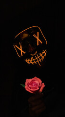 Halloween shot of scary mask and rose
