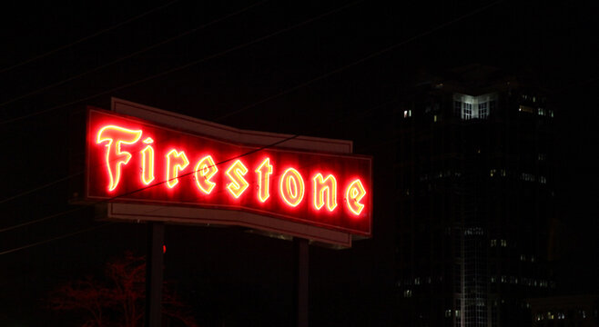 Raleigh, NC, USA - Mar 22 2014: Neon Red Firestone branded sign in downtown Raleigh, lit up at night