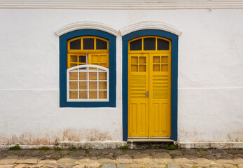 Fototapeta na wymiar old rustic wooden yellow door and yellow window