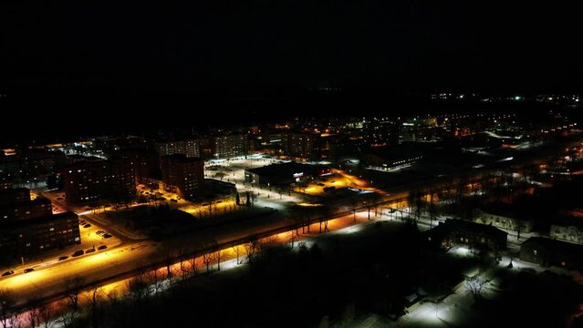 Aerial footage of frozen City at night in the snow. Night city landscape.