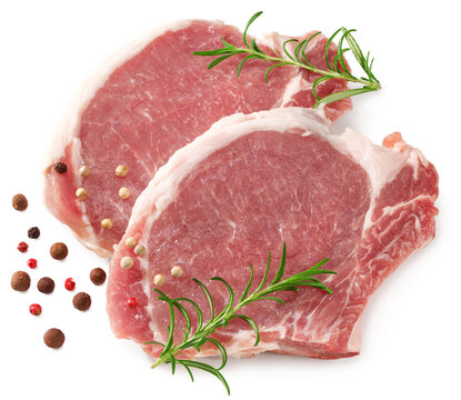 sliced raw pork meat with rosemar and peppercorn isolated on white background. Clipping path and full depth of field. Top view