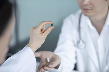 Obraz na płótnie Canvas Close up of doctor holding pills