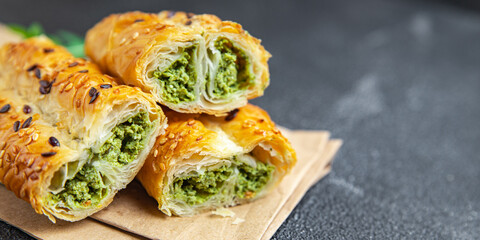 rollini savory pastries spinach, cheese puff pastry fresh phyllo dough healthy meal takeaway food snack on the table copy space food background 