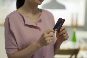 Woman holding credit card in store