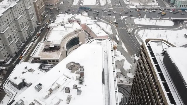 Drone slowly flies over the temple on Tverskaya Zastava overlooking skyscrapers and road traffic