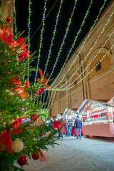 The Christmas markets in the center of Montalcino during the Christmas period among decorations and Christmas trees.