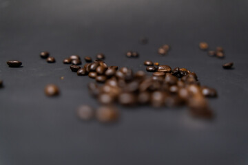 Pile of roasted coffee beans with dark gray background