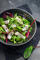 Easter salad herring fish slices seafood green leaf lettuce fresh healthy meal Easter food diet snack on the table copy space food background 