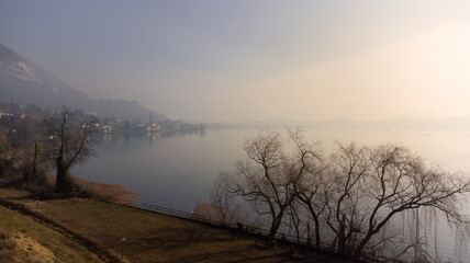 Morning mist floating over the Lake with little village in the background