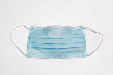 Surgical face mask isolated on white background. Covid-19 face covering mandate, requirement and health care concept.