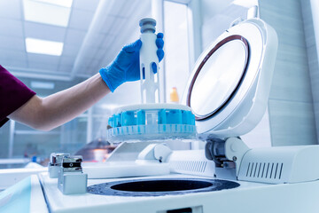 Laboratory assistant works with microwave hybrid tissue processor at the modern laboratory.