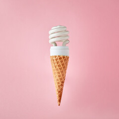Light bulb on ice cream cone on pink background. Creativity, innovation, idea or discovery