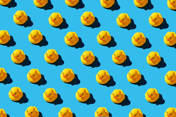 Yellow rubber duck toys pattern on seamless blue background. - Powered by Adobe