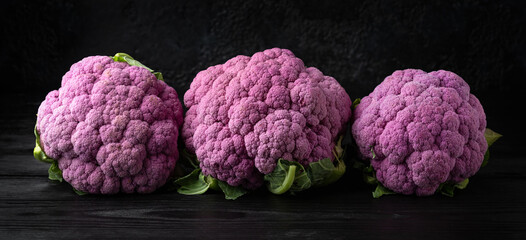 Purple colourful cauliflower on black wooden table