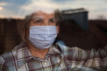 Elderly caucasian woman wearing handmade protective face mask