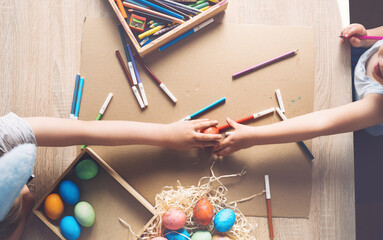 Children prepare for easter. Kids painting easter eggs. Easter background, flat lay, top view.