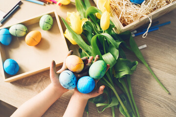 Children prepare for easter. Kids painting easter eggs. Easter background, flat lay, top view.