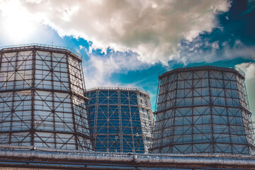 Thermal power plant for generating electricity against a blue sky with clouds. Power generation