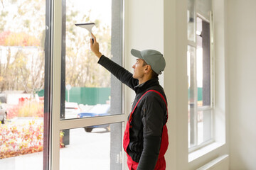 Professional cleaning, man washes window