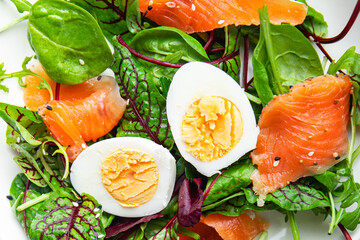 salad salted salmon, eggs, green leaves lettuce fresh portion healthy meal food diet snack on the table copy space food background rustic keto or paleo diet veggie vegetarian pescatarian diet