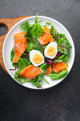 salad salted salmon, eggs, green leaves lettuce fresh portion healthy meal food diet snack on the table copy space food background rustic keto or paleo diet veggie vegetarian pescatarian diet