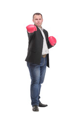 Business man ready to fight with boxing gloves looking at camera