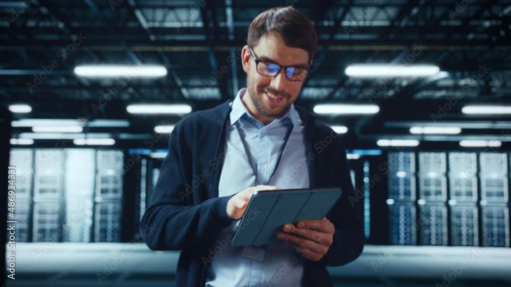 Fototapete Male IT Specialist Walks Between Row of Operational Server Racks in Data Center. Engineer Uses Tablet Computer for Maintenance and Diagnostics in Cyber Security and Data Protection Facility.