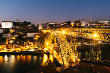 View of the city of Porto with the Don Luis bridge illuminated.