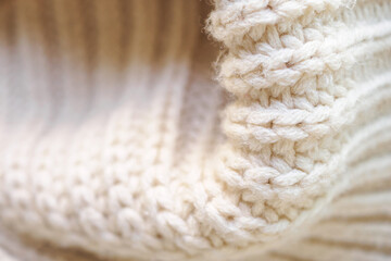 closeup beige knitted woolen fabric texture background