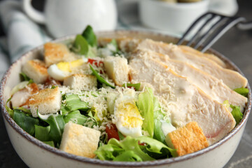 Delicious Caesar salad in bowl, closeup view