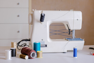 Electric sewing machine and spools of thread on the table