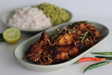 Spicy chicken fry garnished with caramelised onions, served as side dish of kerala rice meal